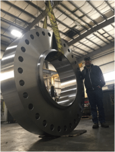 carlson employee standing next to a custom flange