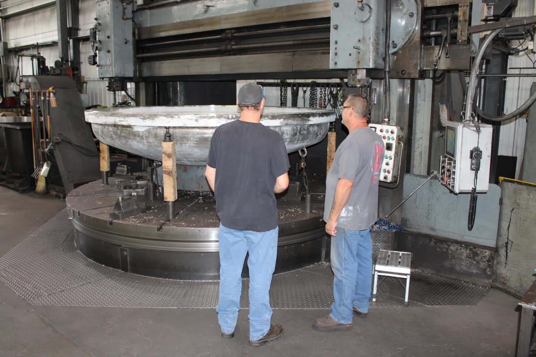 Two Carlson employees looking at a part